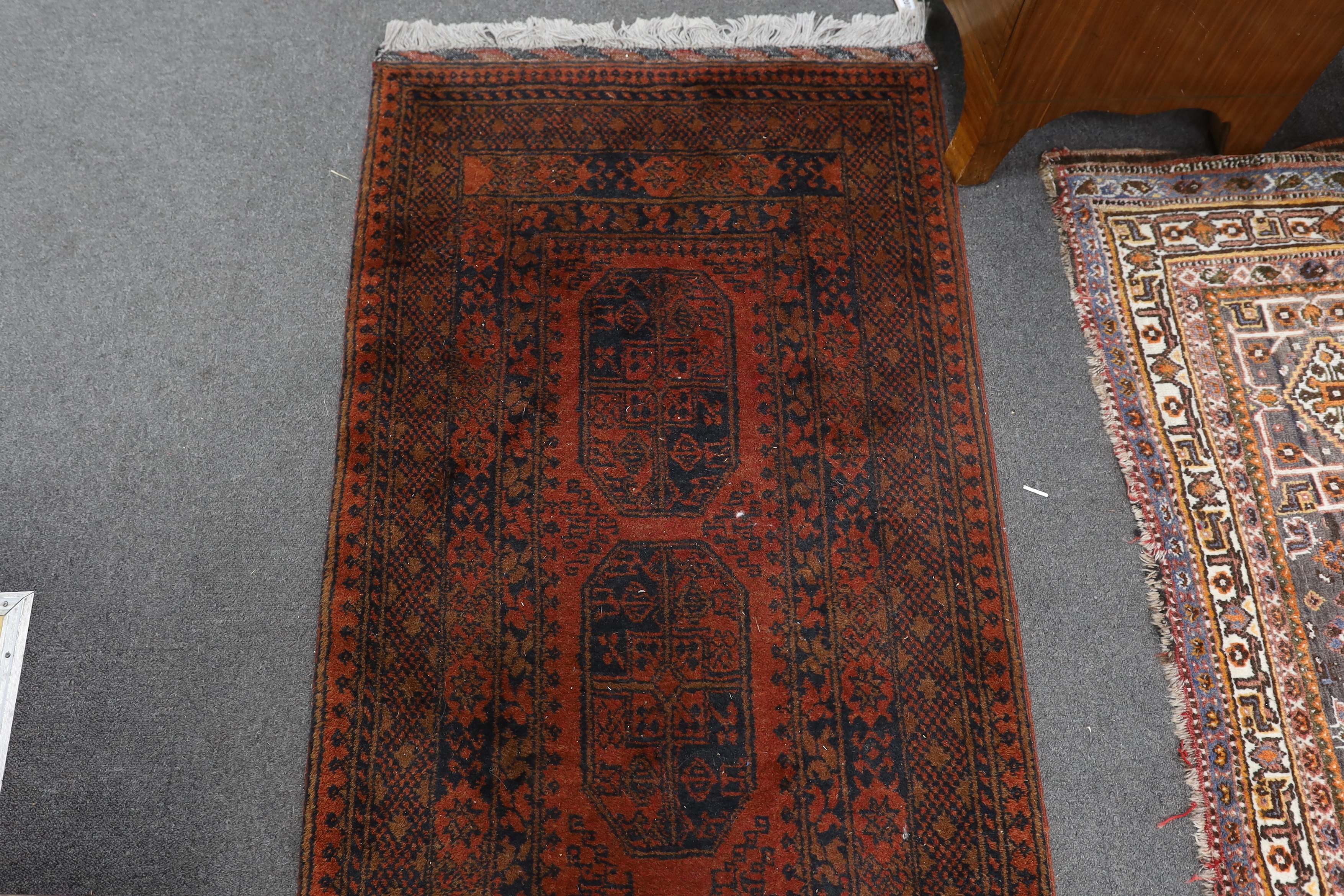 An Afghan red ground runner, 290 x 79cm